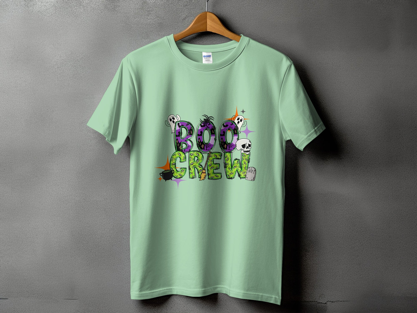 Light mint green t-shirt with "BOO CREW" Halloween graphic featuring ghosts and skulls.