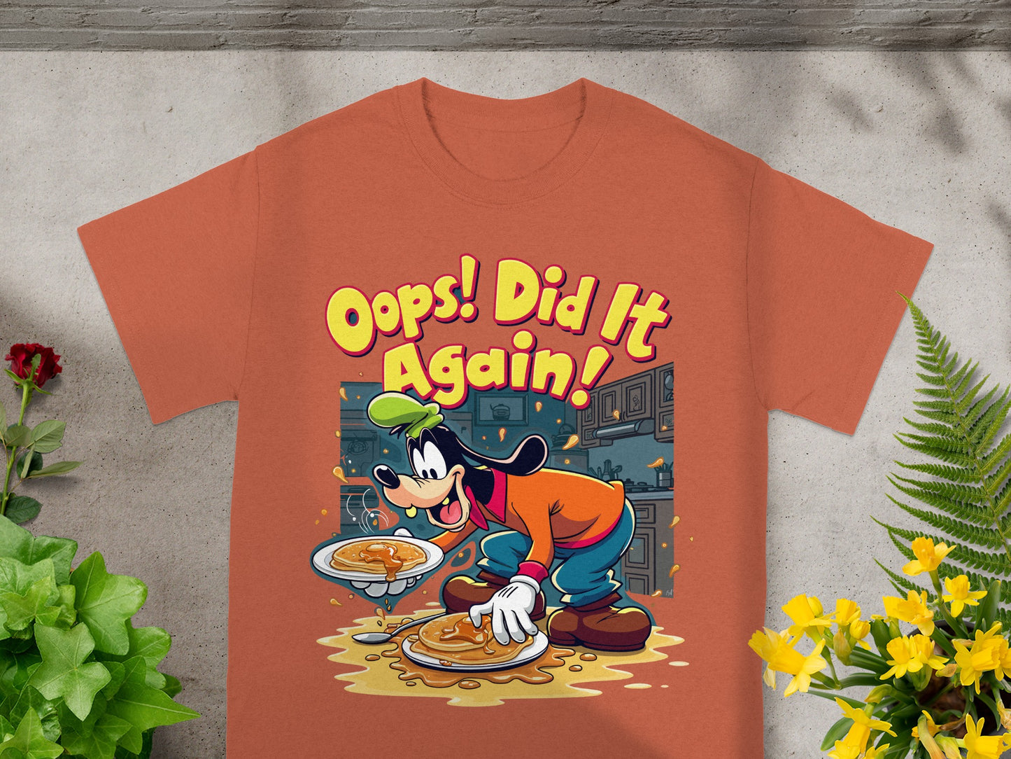 T-shirt with cartoon Goofy spilling pancakes, text "Oops! Did It Again!".