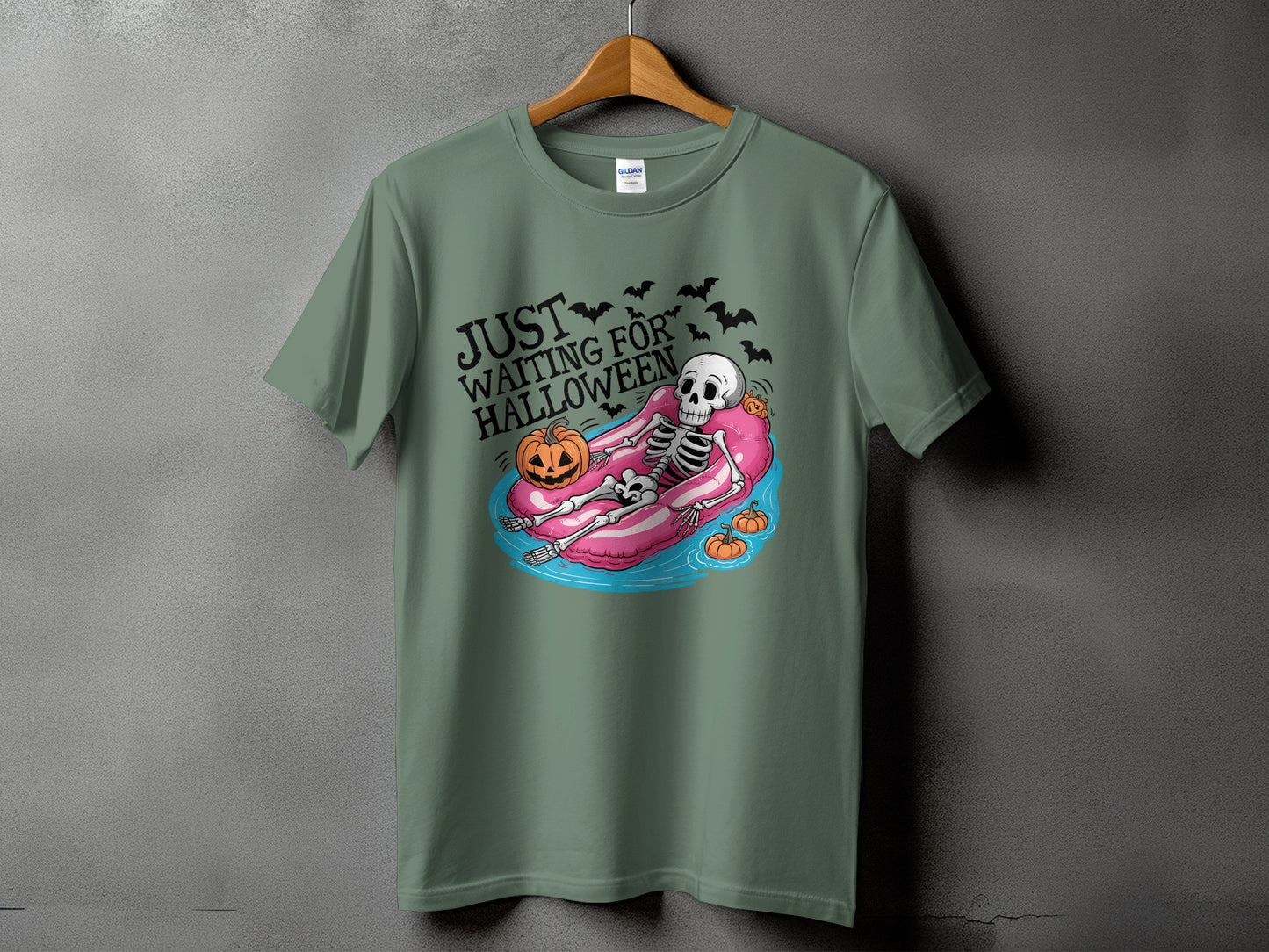 Green t-shirt with skeleton in inner tube and text "Just Waiting For Halloween."