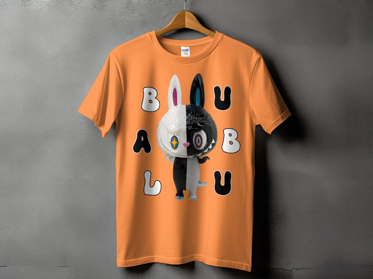 Orange t-shirt with a black and white creature and the text "BALU".