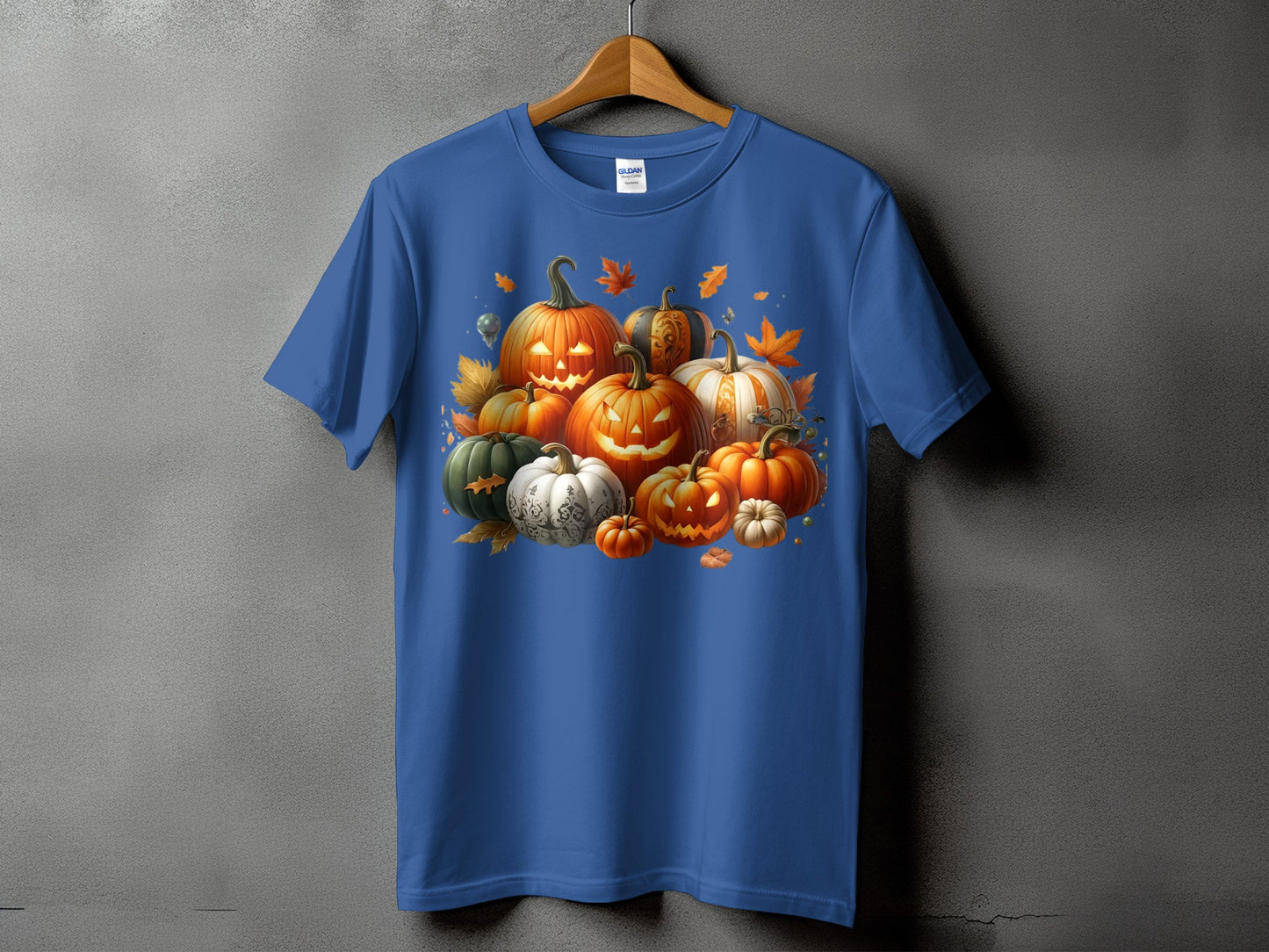 Blue t-shirt with a Halloween pumpkin patch graphic and falling autumn leaves.
