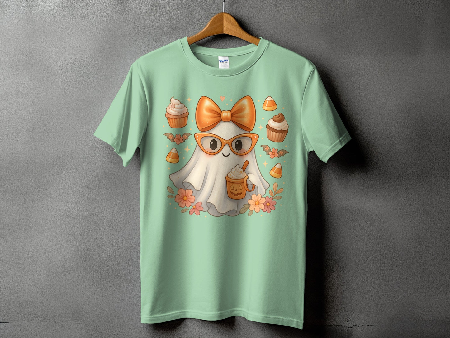 Ghost wearing glasses and bow, holding a pumpkin mug, surrounded by cupcakes and candy corn.