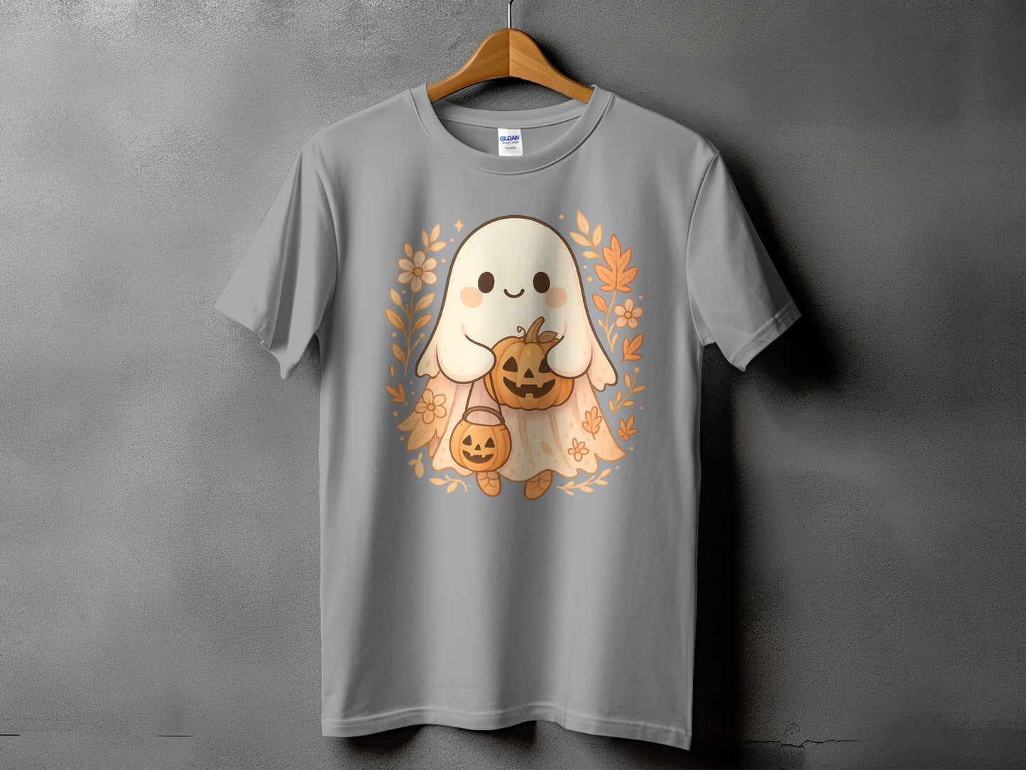 Gray t-shirt with a cute ghost holding pumpkins and surrounded by autumn leaves.