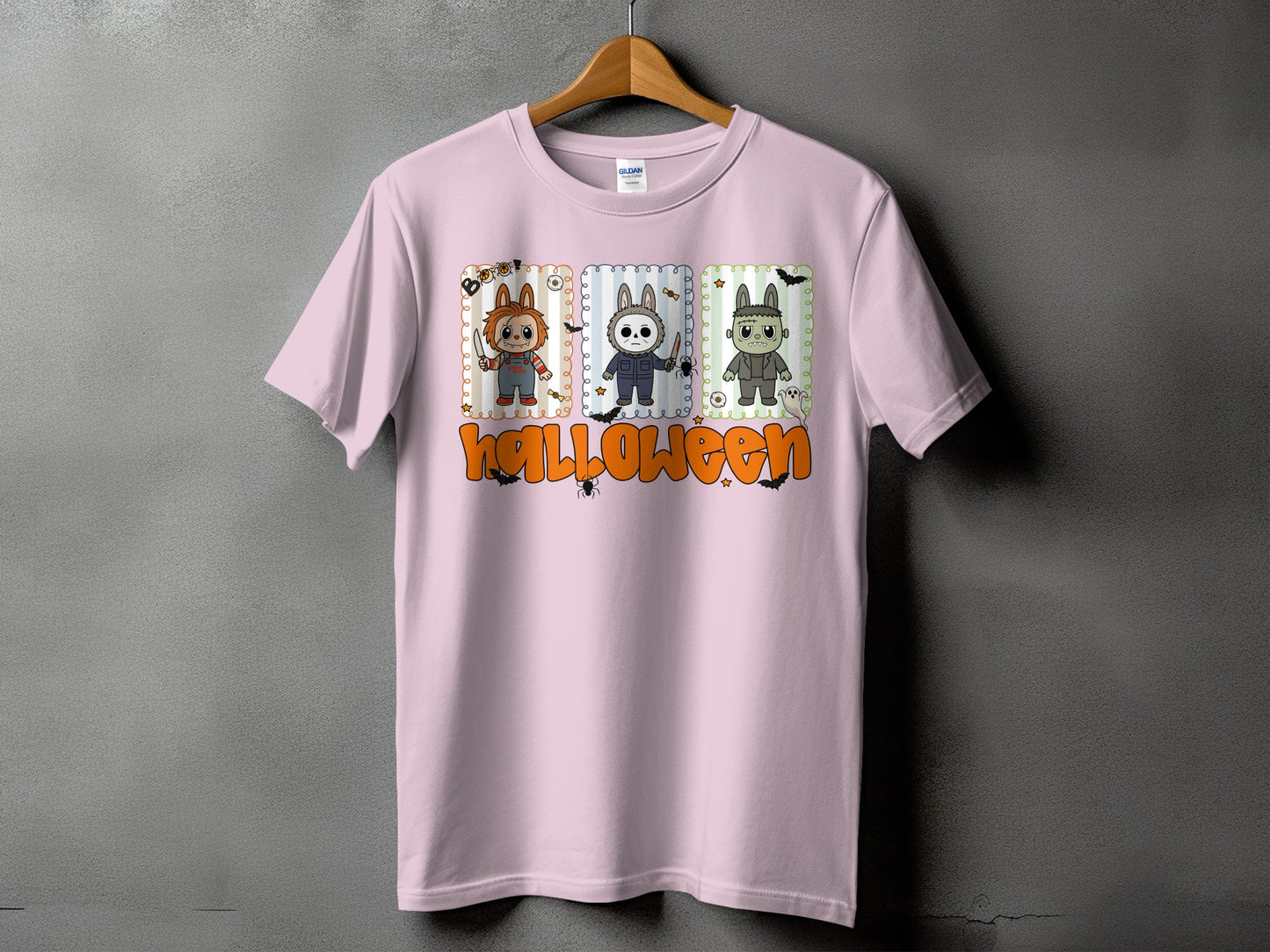 Pink t-shirt with cartoon Chucky, Michael Myers, and Frankenstein characters with "Halloween" text.