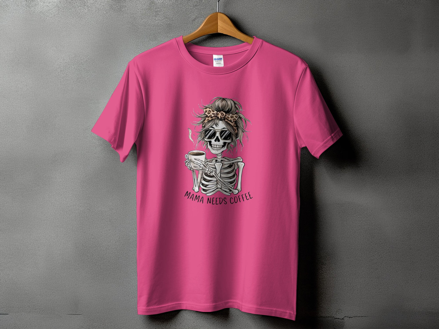 Pink t-shirt with skeleton graphic and "Mama Needs Coffee" text.
