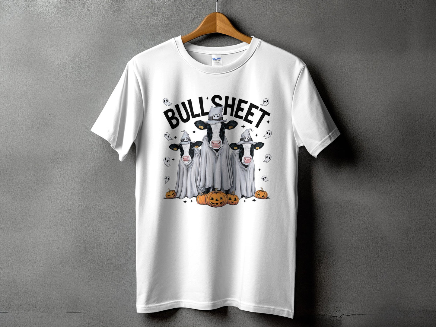 White t-shirt with three cows dressed as ghosts and wearing witch hats.