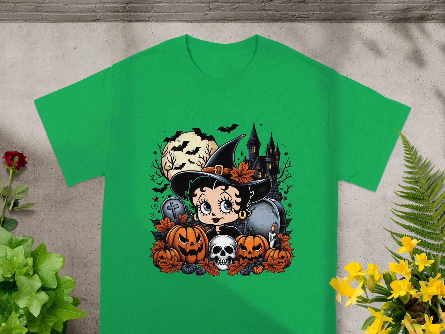 Betty Boop as a witch surrounded by pumpkins, skulls, and a haunted castle.