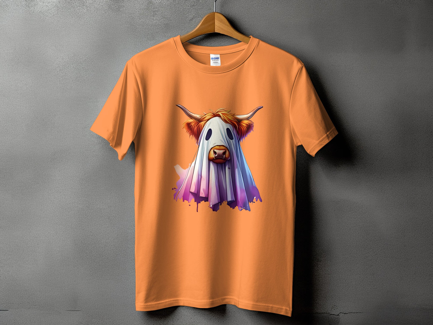 Orange t-shirt with a Highland cow dressed as a ghost graphic.