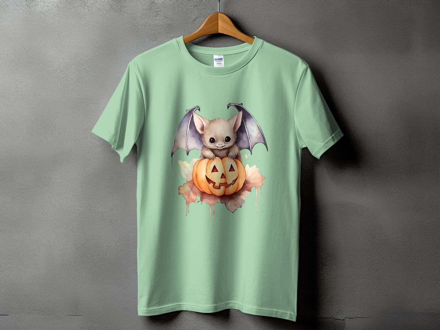 Light green t-shirt with cute bat on a pumpkin graphic.