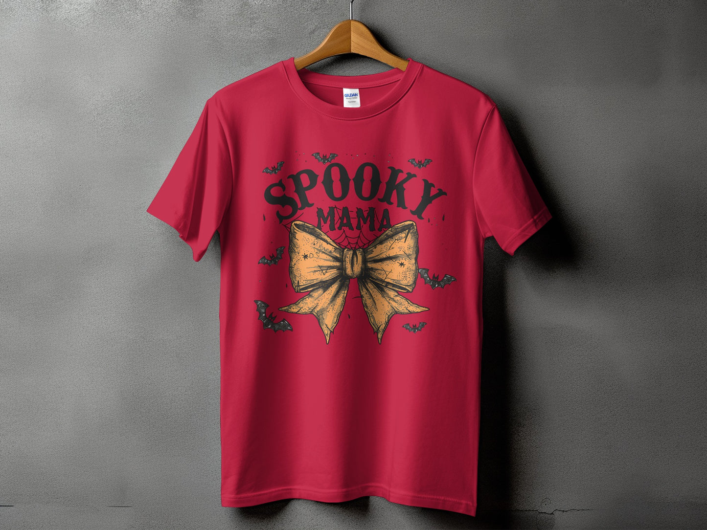 Red t-shirt with "SPOOKY MAMA" text and a large orange bow.