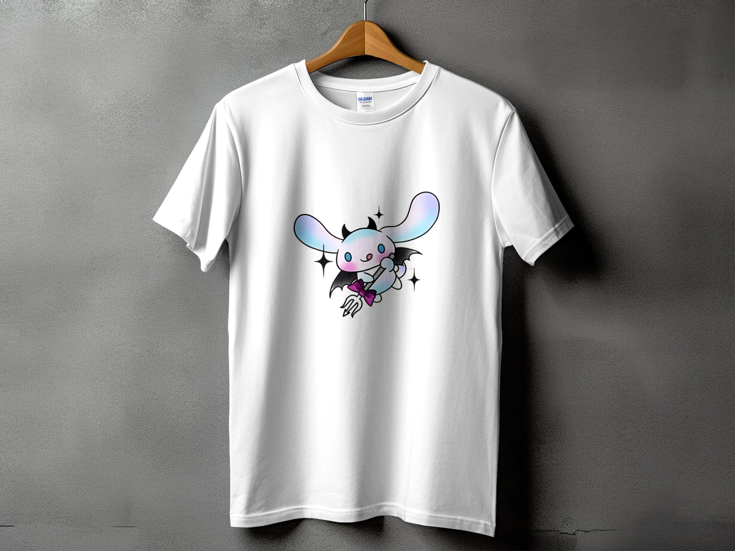 White t-shirt with a cute devilish cartoon character wearing wings and holding a trident.
