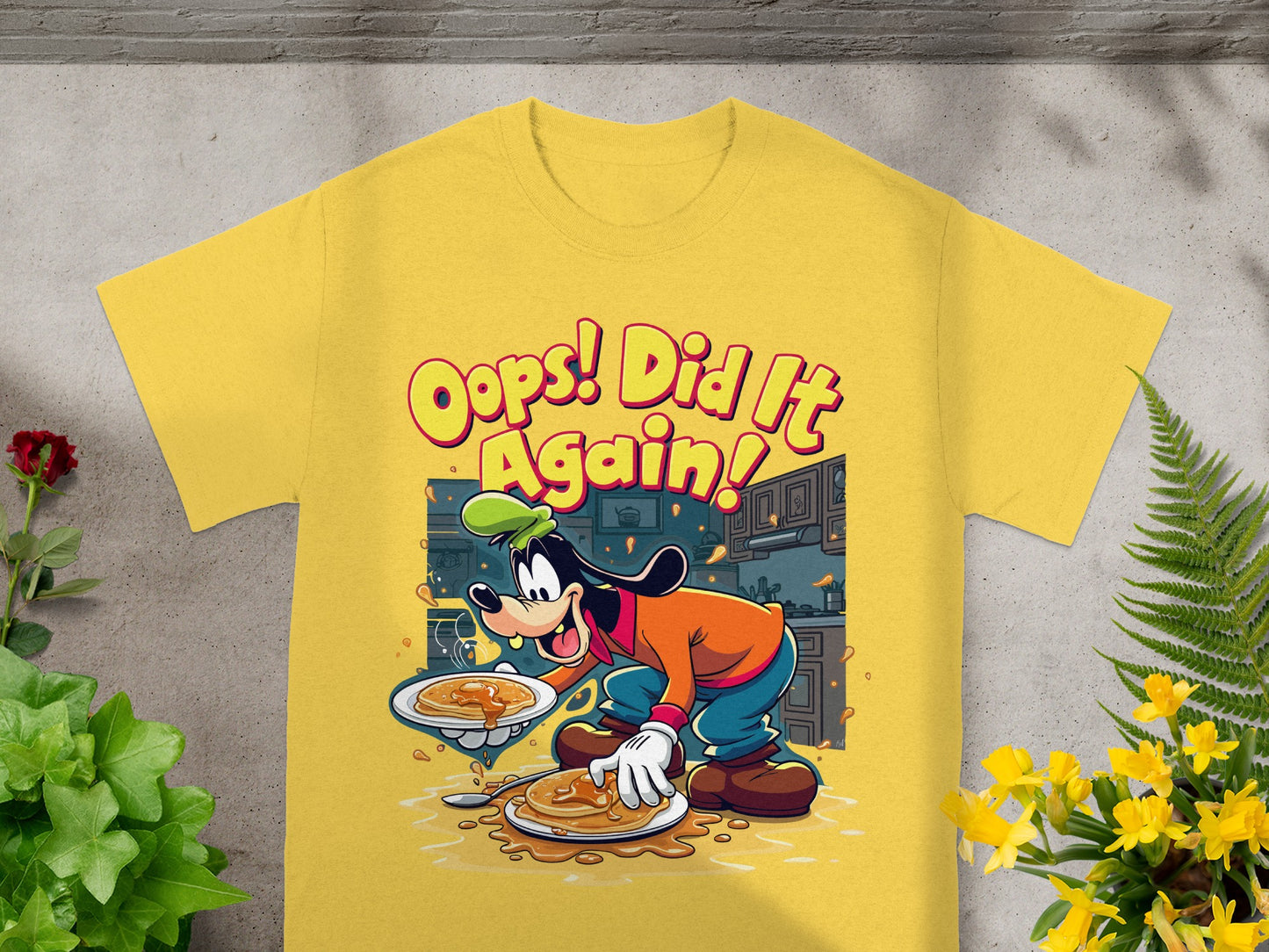 Yellow t-shirt with Goofy holding pancakes, saying "Oops! Did It Again!".
