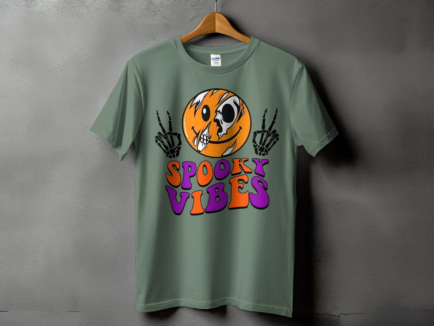 Green t-shirt with skeleton hands, skull face, and "Spooky Vibes" text.