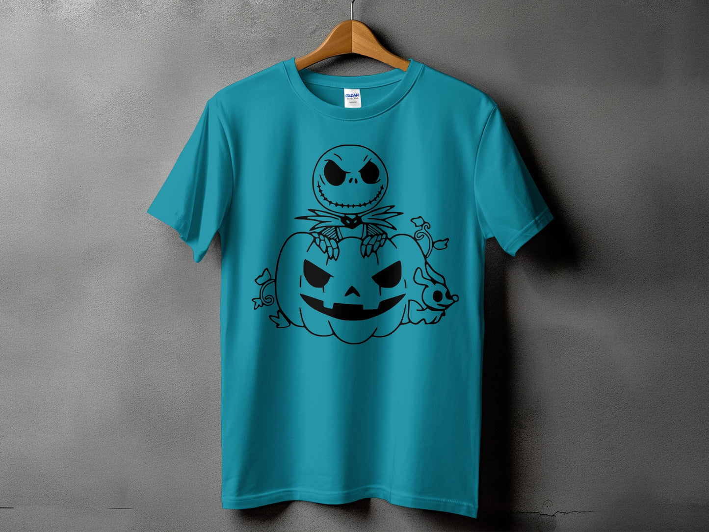 Turquoise t-shirt with black line art of Jack Skellington sitting on a pumpkin.