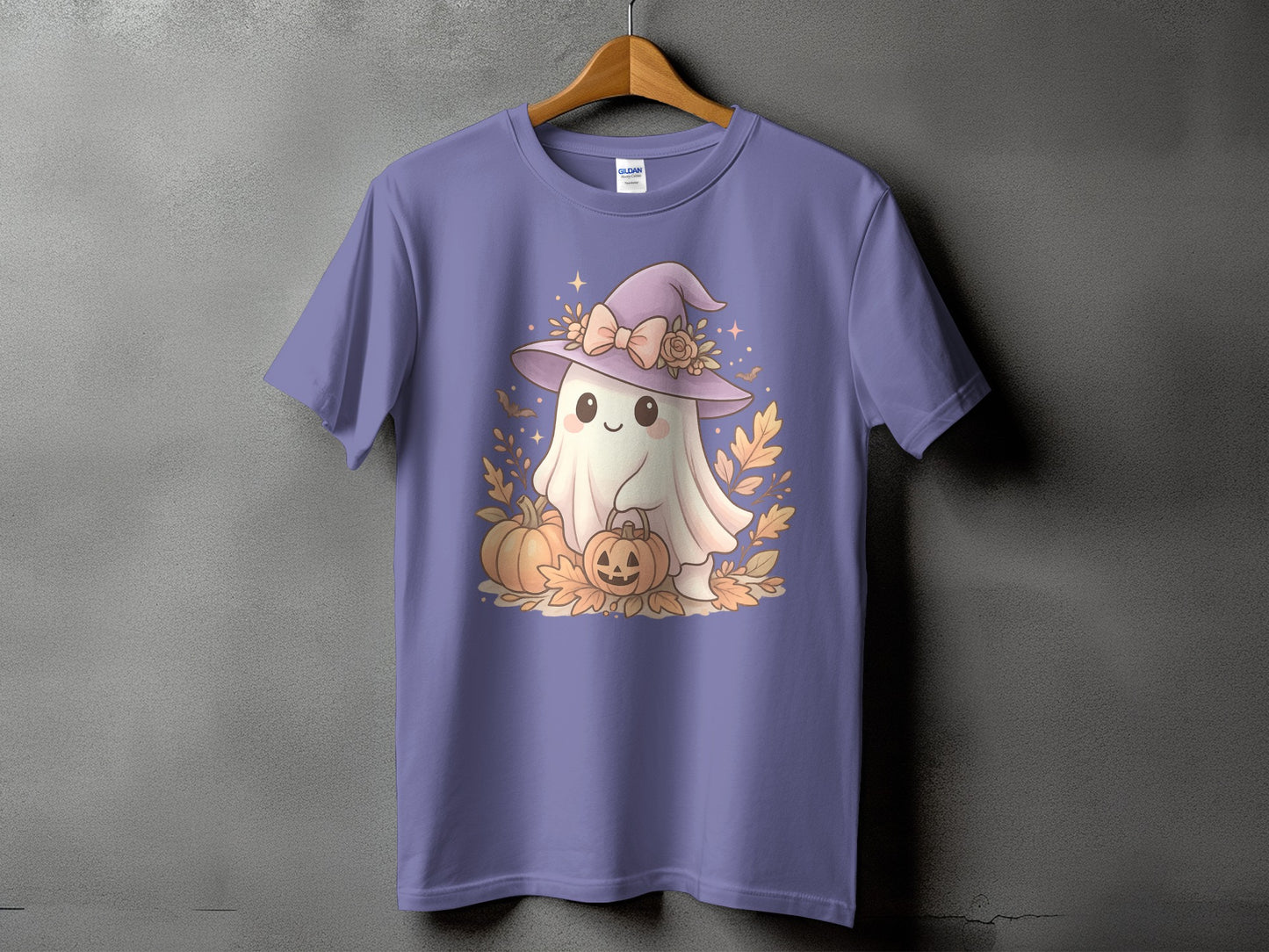 Ghost in witch hat holding pumpkin on purple t-shirt with autumn leaves.