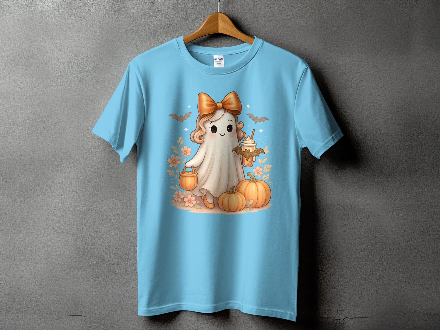 Light blue t-shirt with a cute ghost holding a pumpkin and a drink.