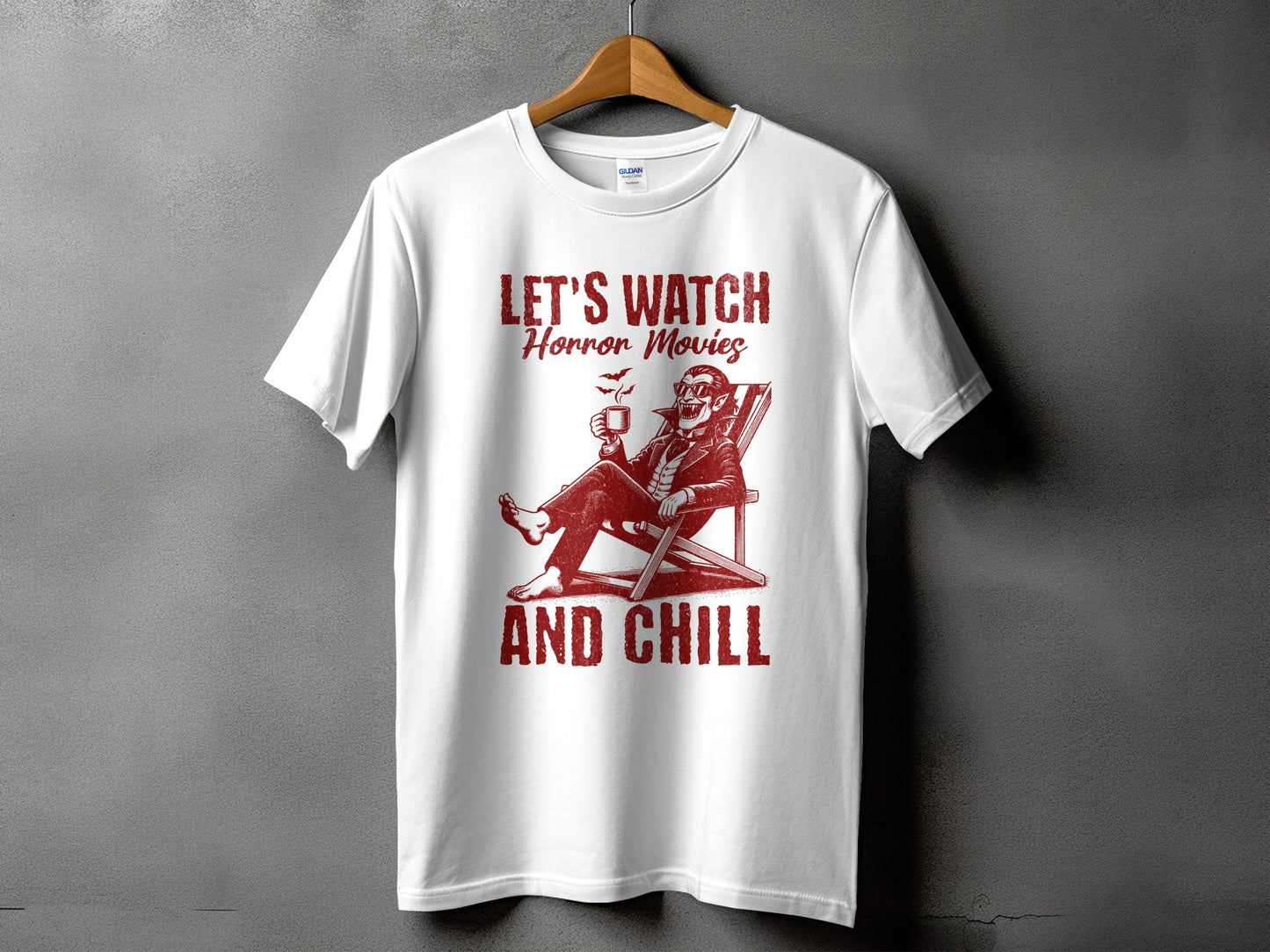 White t-shirt with red graphic of vampire saying "Let's Watch Horror Movies and Chill."