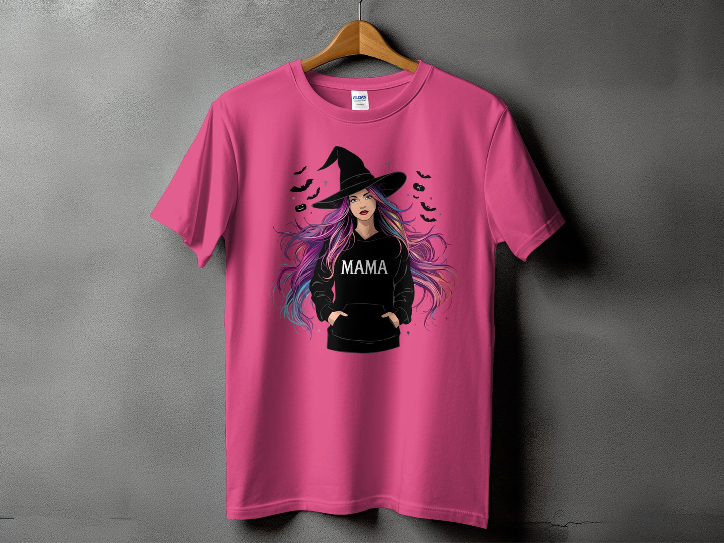 Pink t-shirt with a graphic of a woman in a witch hat, with "MAMA" text.