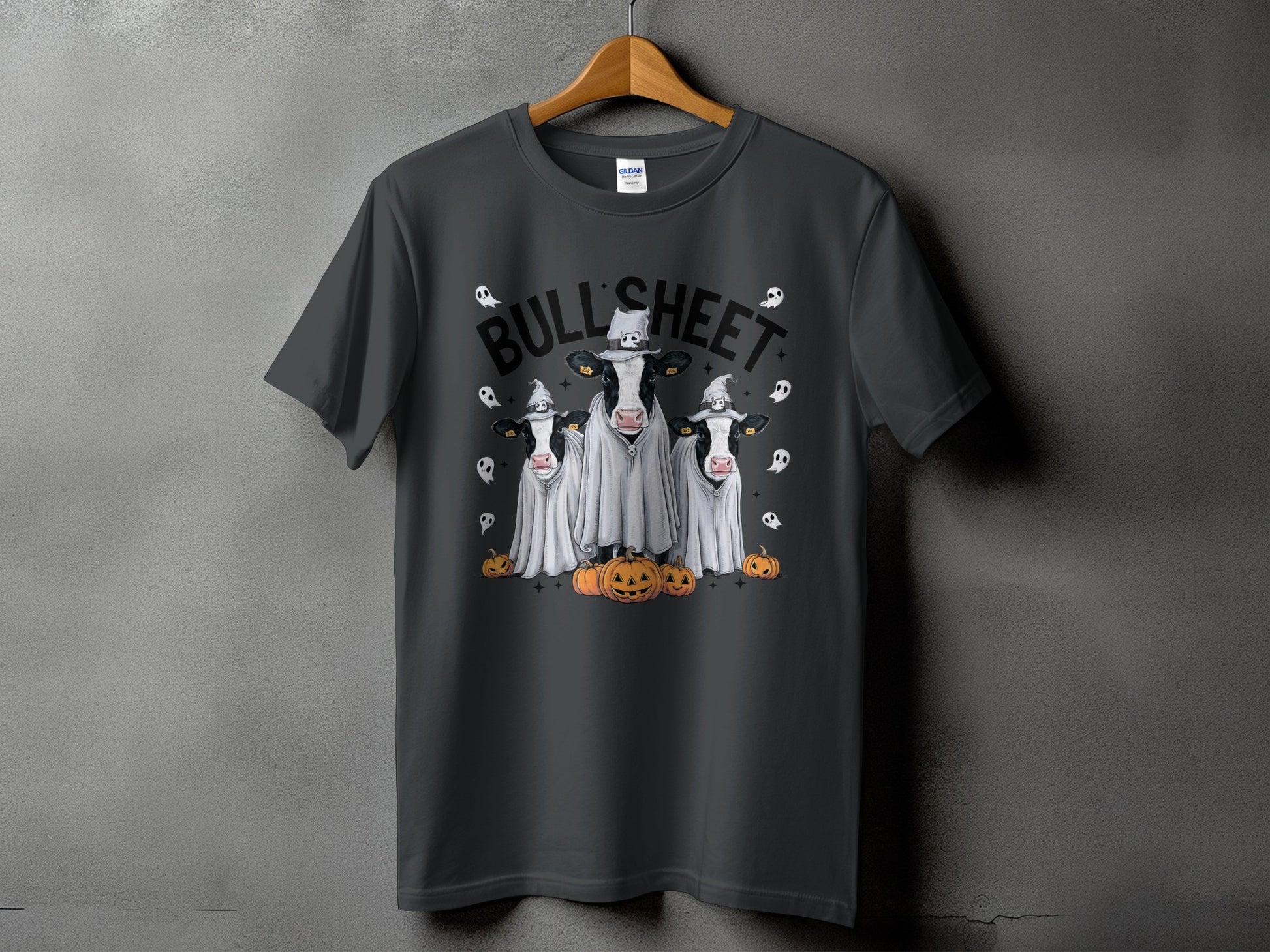 Three cows in ghost costumes with hats and pumpkins with "BULL'SHEET" text.
