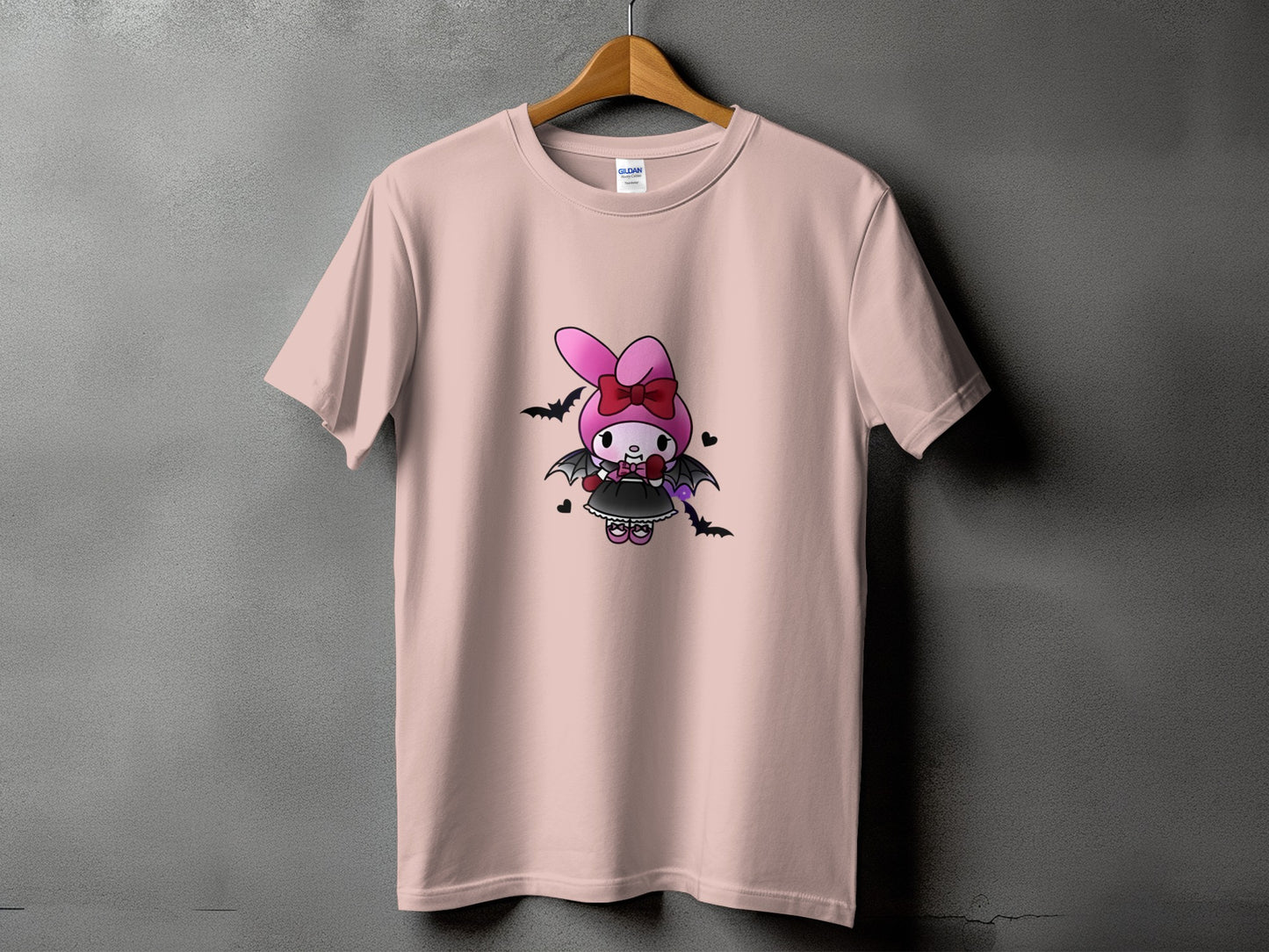 Pink t-shirt with a cartoon bunny character dressed as a vampire.
