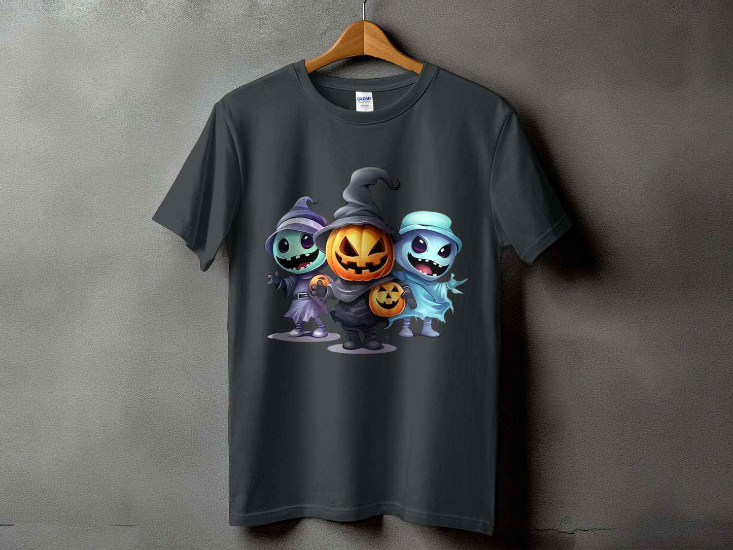 Dark t-shirt with a graphic of three cartoon Halloween characters: pumpkin, witch, and ghost.