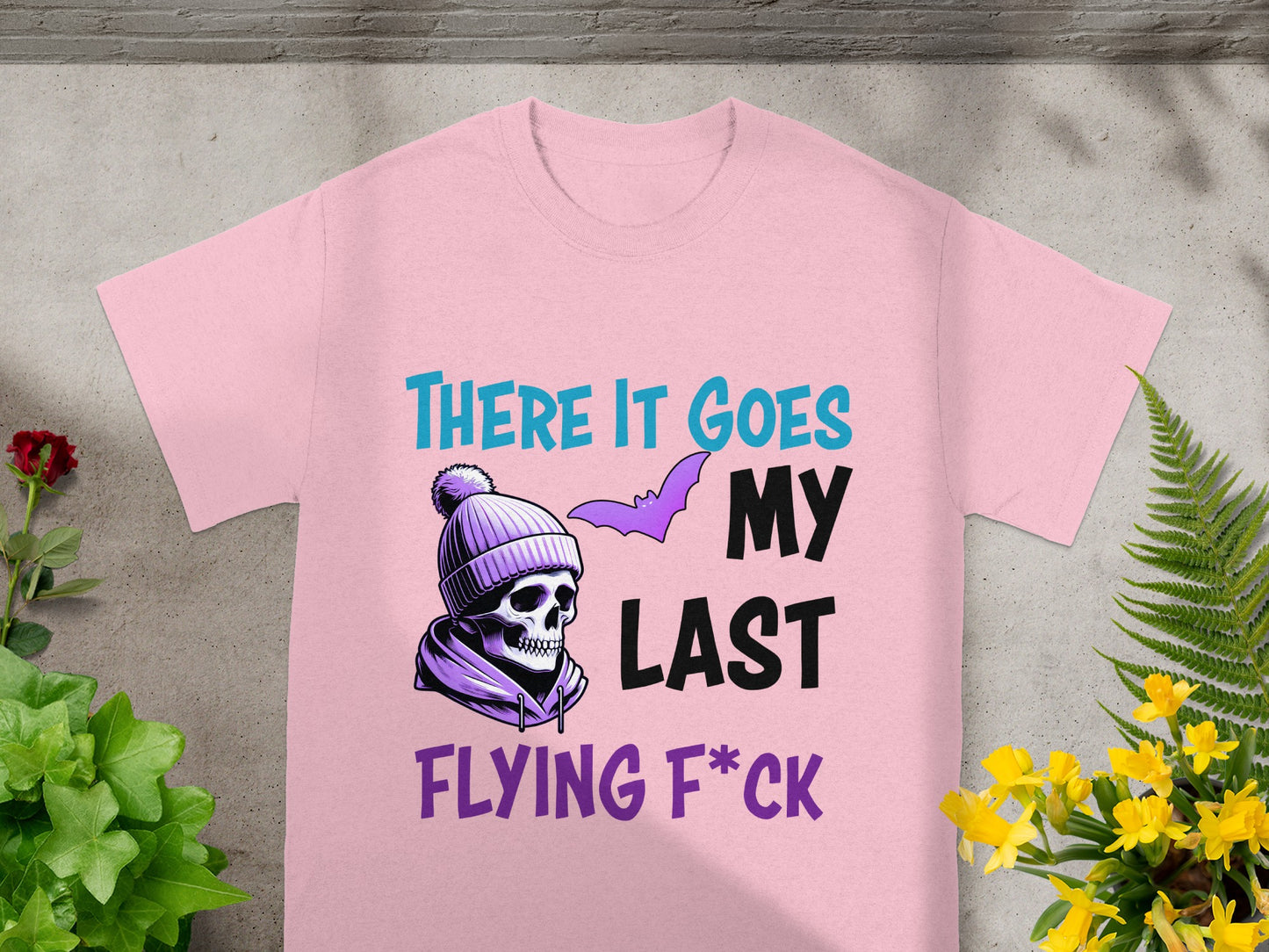 Pink t-shirt with skull, bat, and text: "THERE IT GOES MY LAST FLYING F*CK".