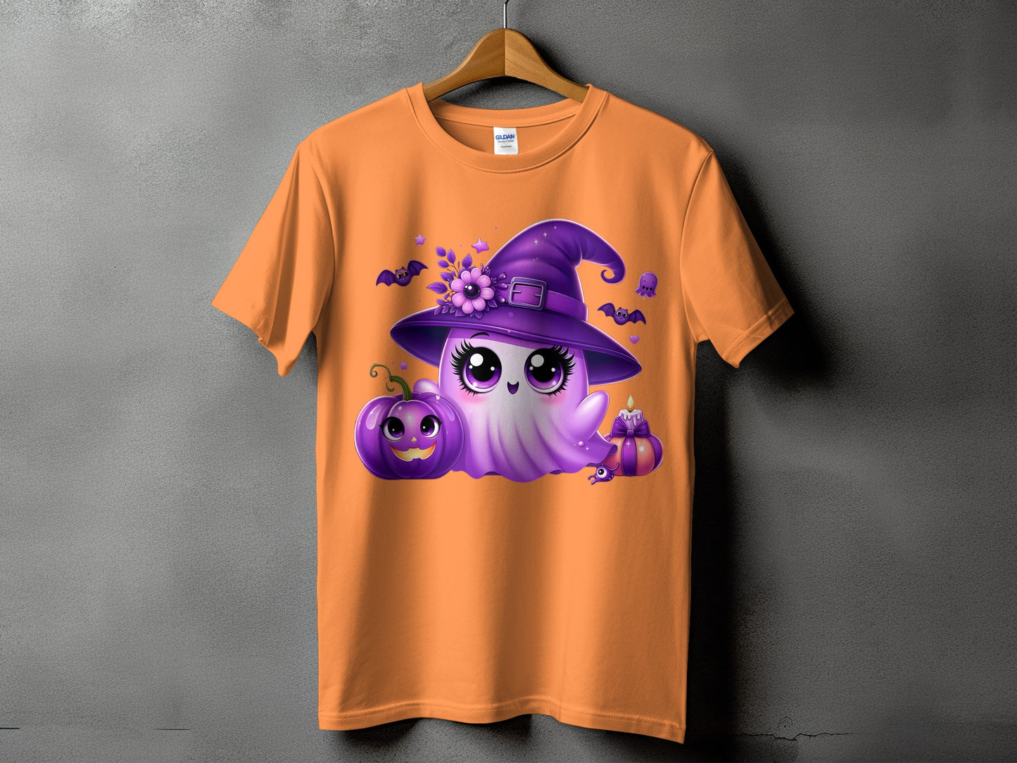 Orange t-shirt with a cute purple ghost wearing a witch hat, pumpkin, and bats.