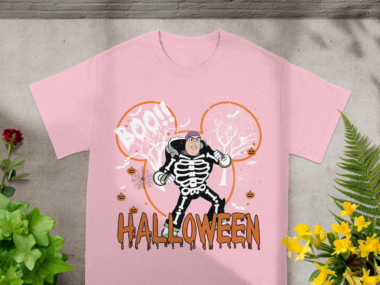 Pink t-shirt with Buzz Lightyear skeleton graphic and "Boo!!" and "Halloween" text.