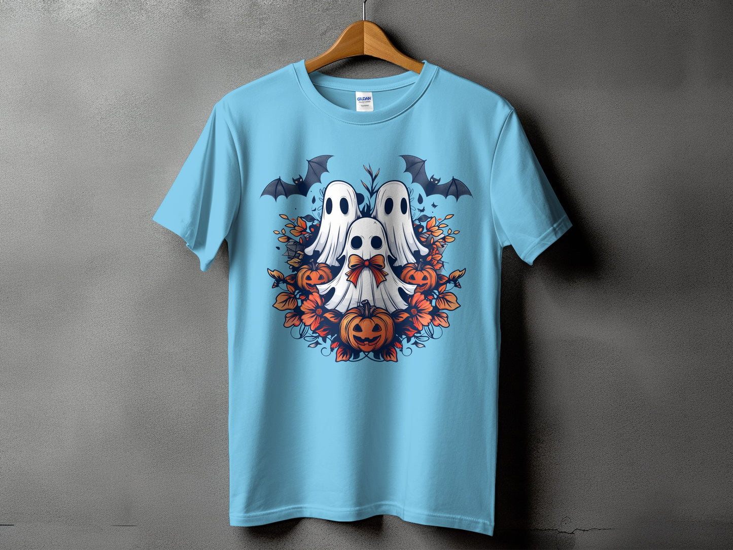 Light blue t-shirt with a Halloween graphic of three ghosts, bats, and pumpkins.
