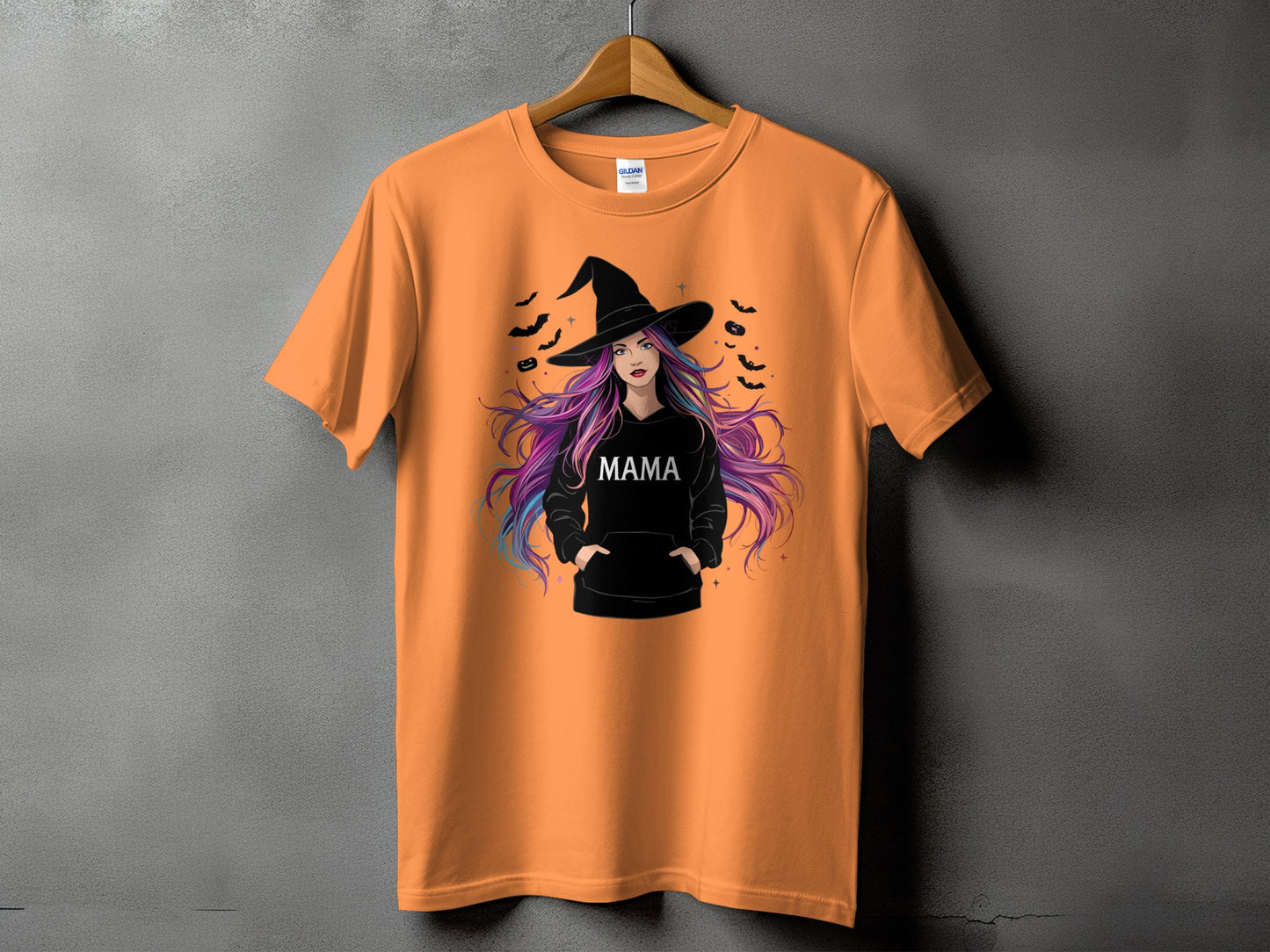 Orange t-shirt with witch graphic and the word "MAMA" in white text.