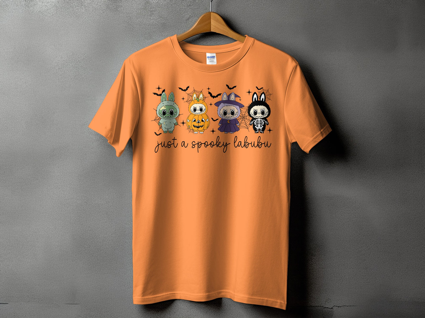 Orange t-shirt with four cute Halloween characters and text that reads "just a spooky labubu."