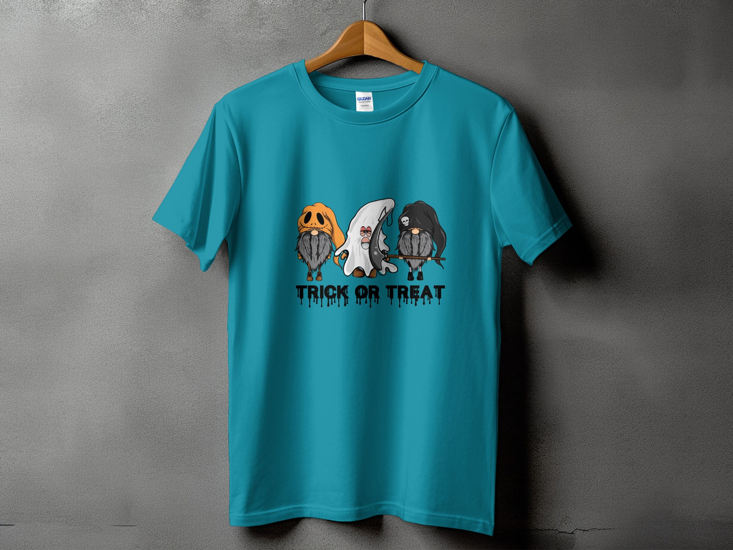 Teal t-shirt with three gnomes dressed for Halloween, reading "TRICK OR TREAT."