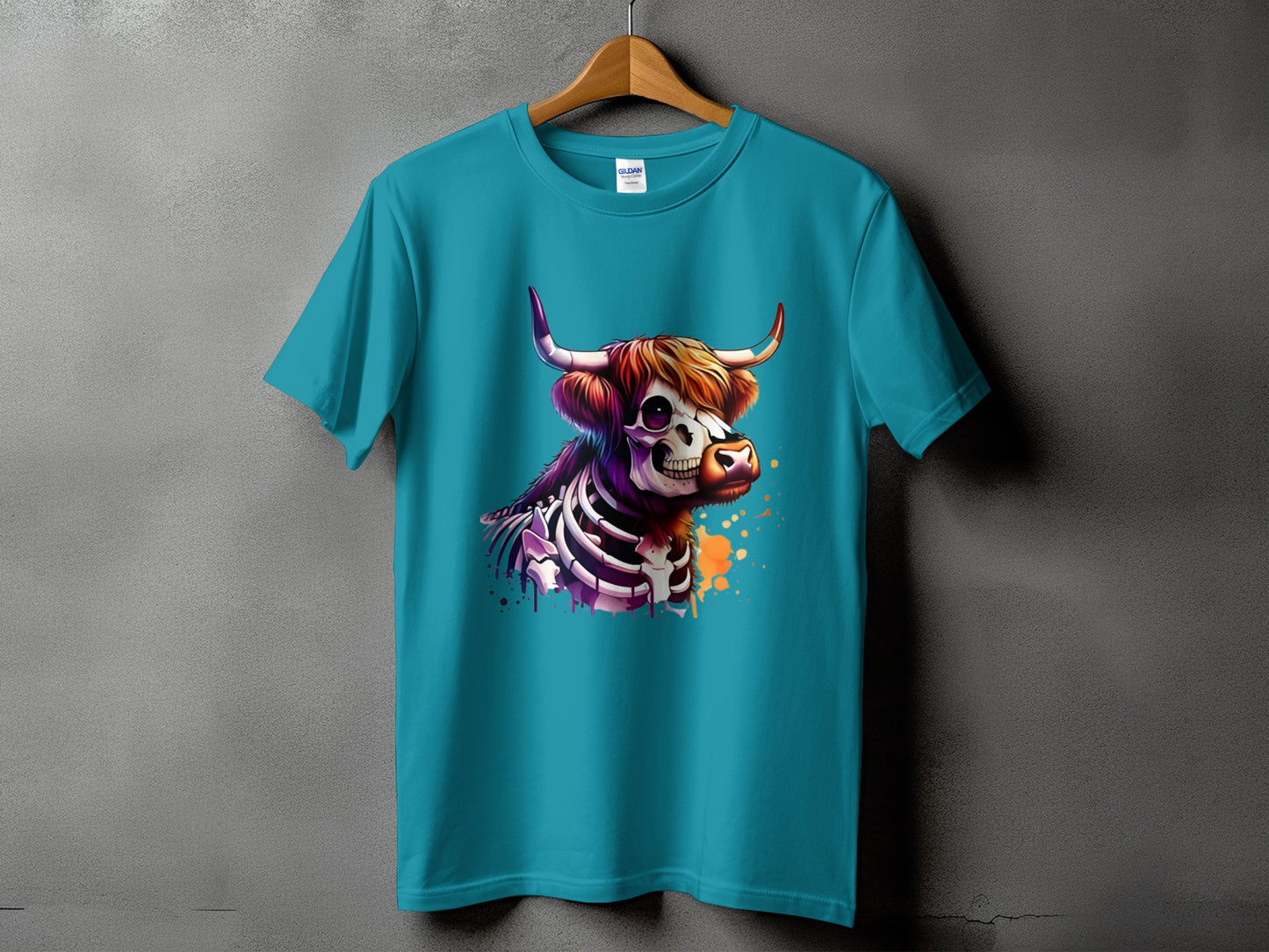 Turquoise t-shirt with a skeleton highland cow graphic and colorful paint splatters.