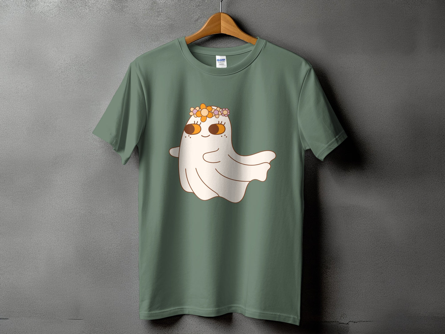 Green t-shirt with a cartoon ghost wearing a flower crown and big eyes.