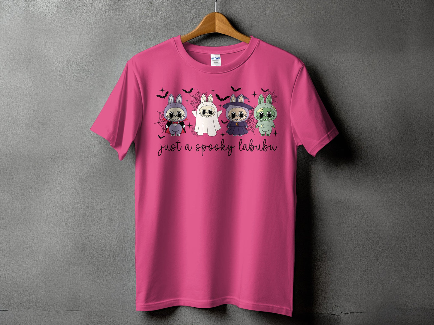 Pink t-shirt with four cartoon monsters and text "just a spooky labubu".