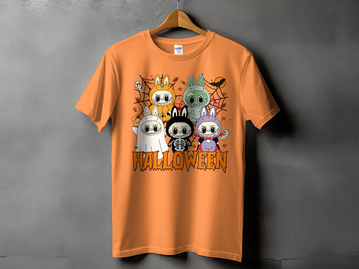 Orange t-shirt with cartoon Halloween characters and text.