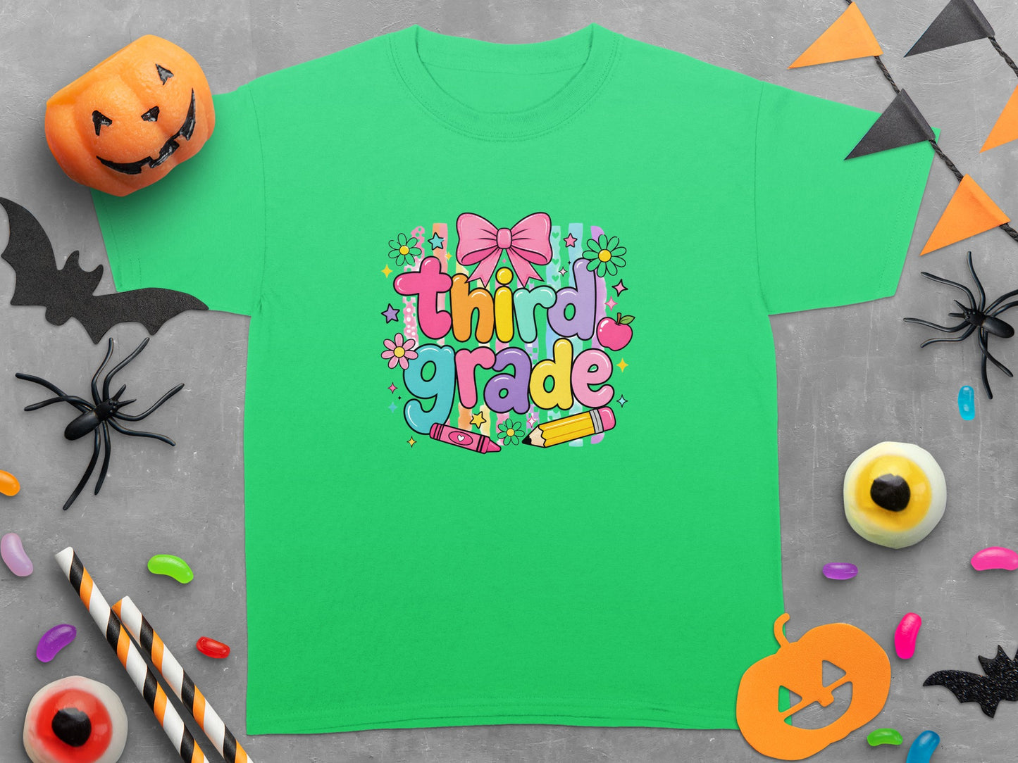 Green t-shirt with "Third Grade" text and Halloween decorations including pumpkins and bats.