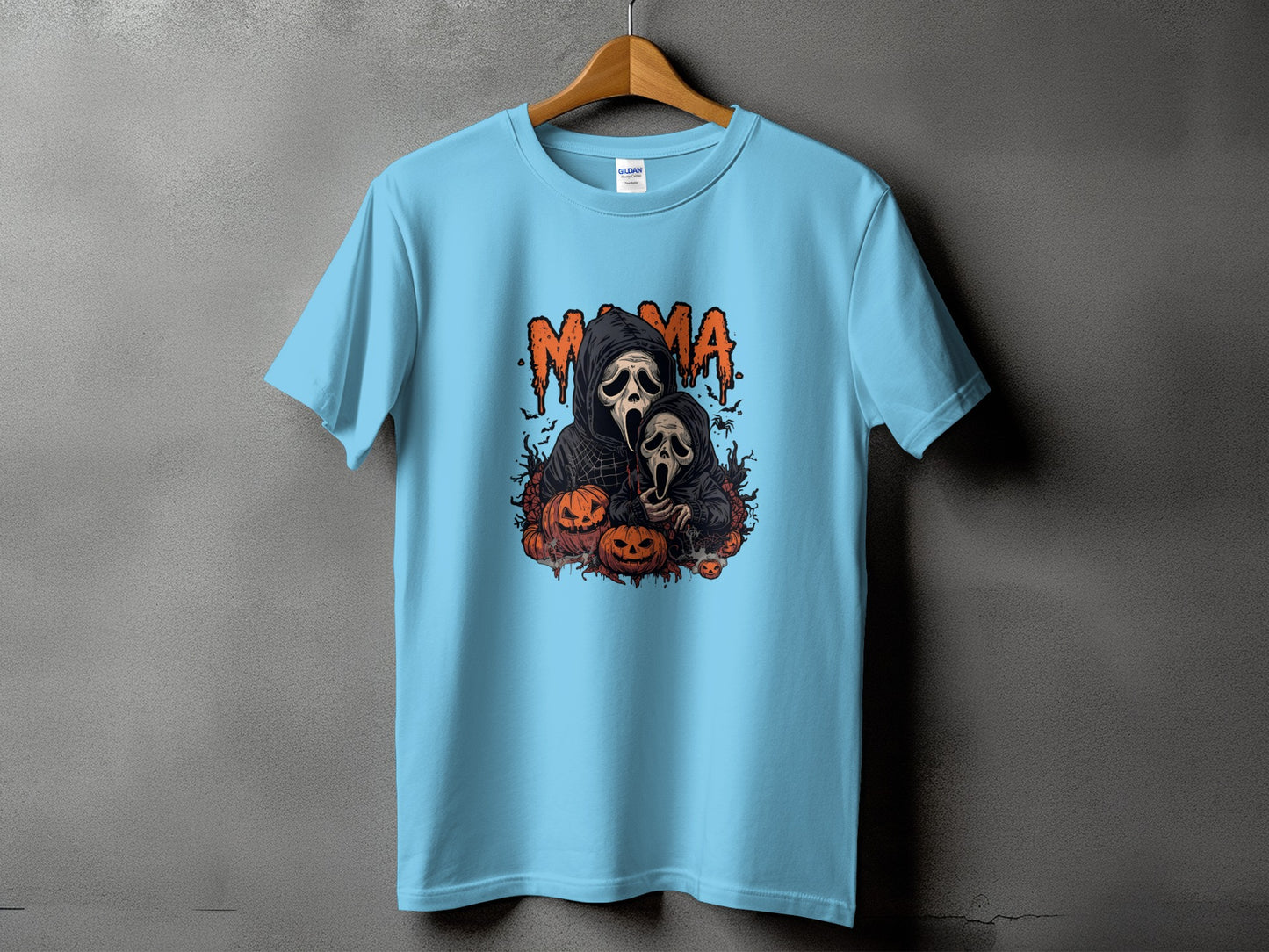 Light blue t-shirt with "Mama" text and a spooky ghost couple surrounded by pumpkins.