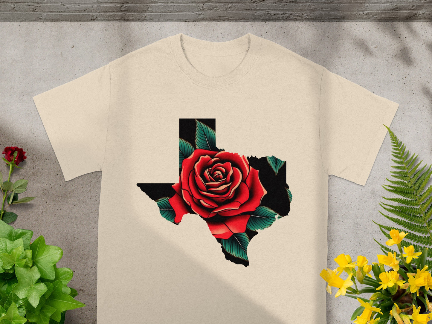 T-shirt with Texas outline filled with a red rose and green leaves.