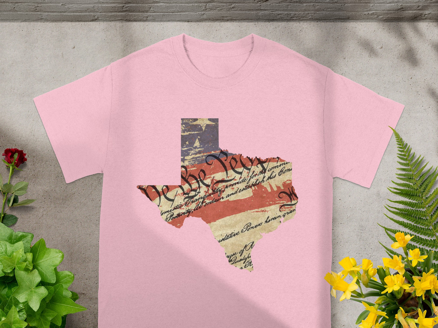 Pink t-shirt with Texas shape featuring US flag and Constitution text.