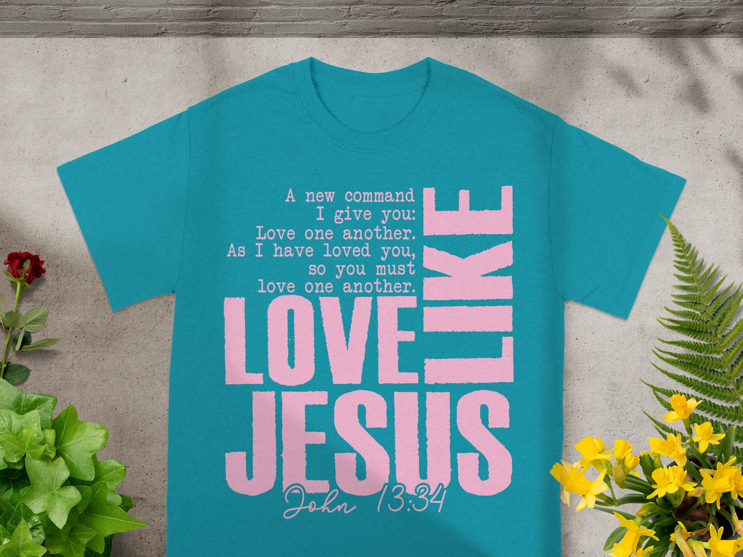 Teal t-shirt with pink text: "Love Jesus like" and Bible verse John 13:34.