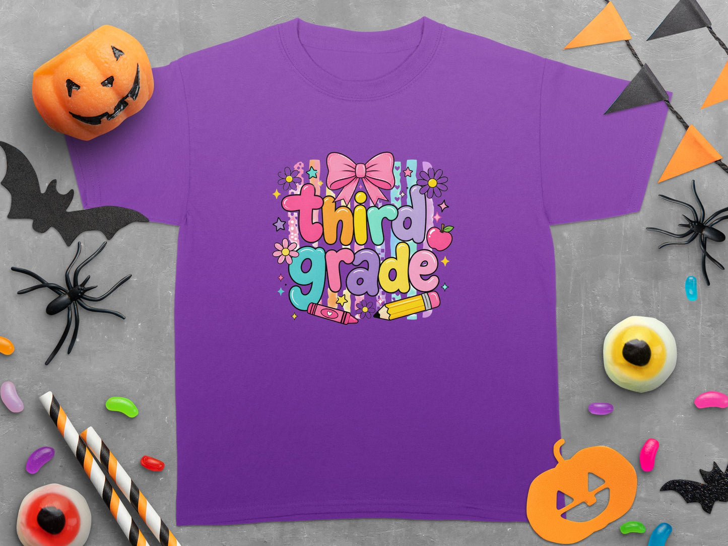 Purple t-shirt with "third grade" graphic and Halloween decorations.