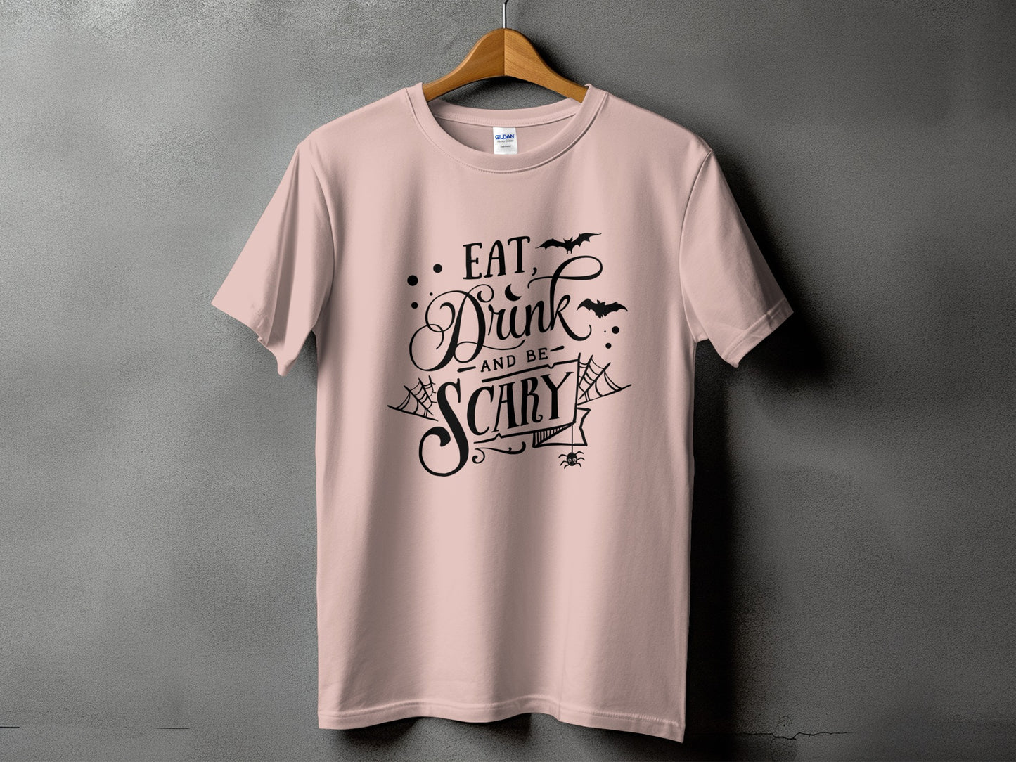 Pink t-shirt with black Halloween graphic: "Eat, Drink and be Scary".