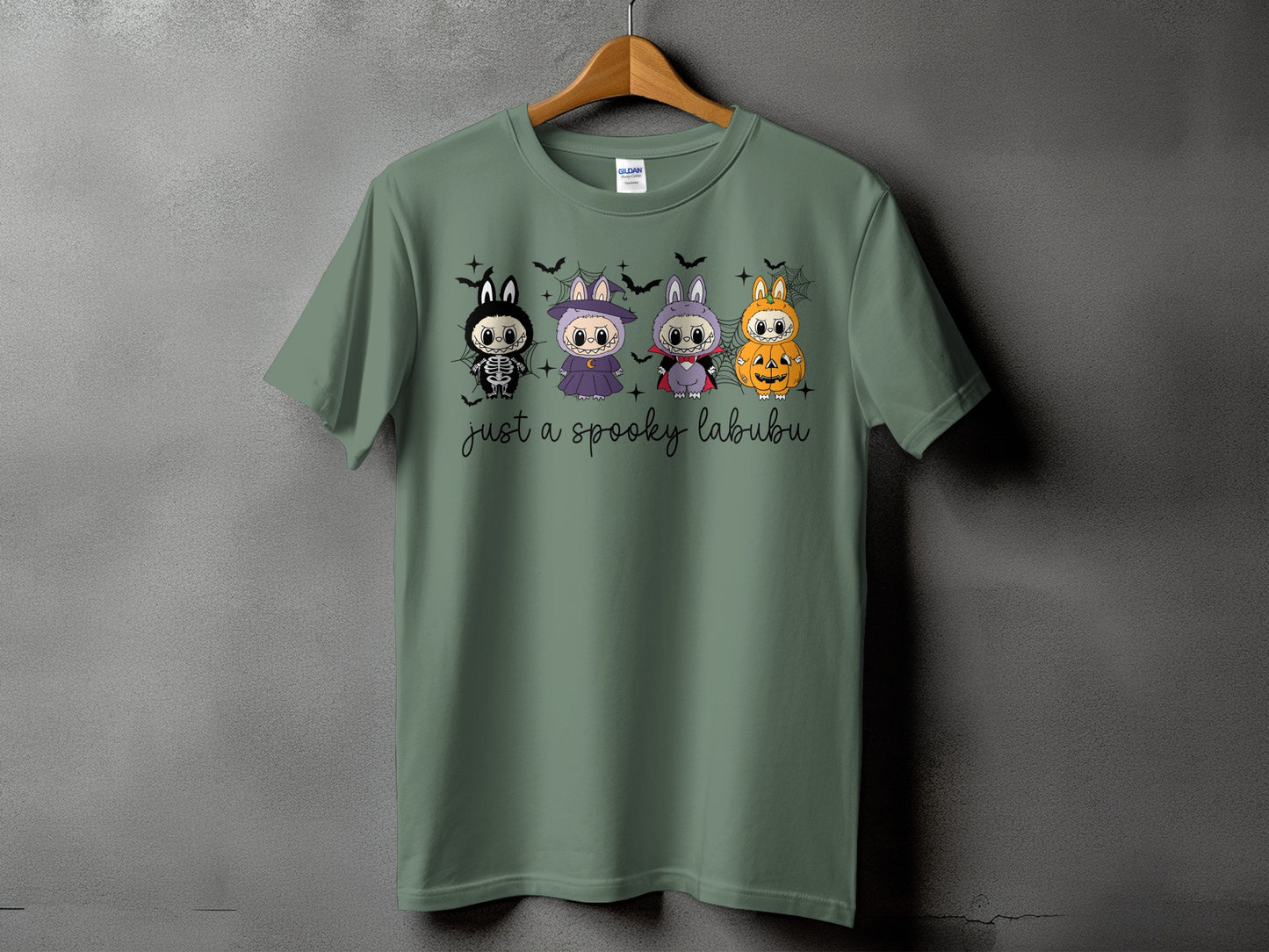 Green t-shirt with four Halloween-themed Labubu characters and text "just a spooky labubu".