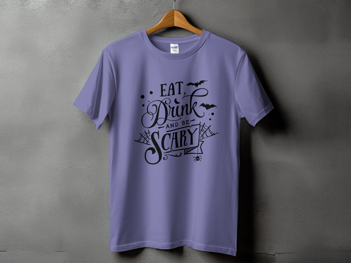 Purple t-shirt with "Eat, Drink, and Be Scary" Halloween text design.