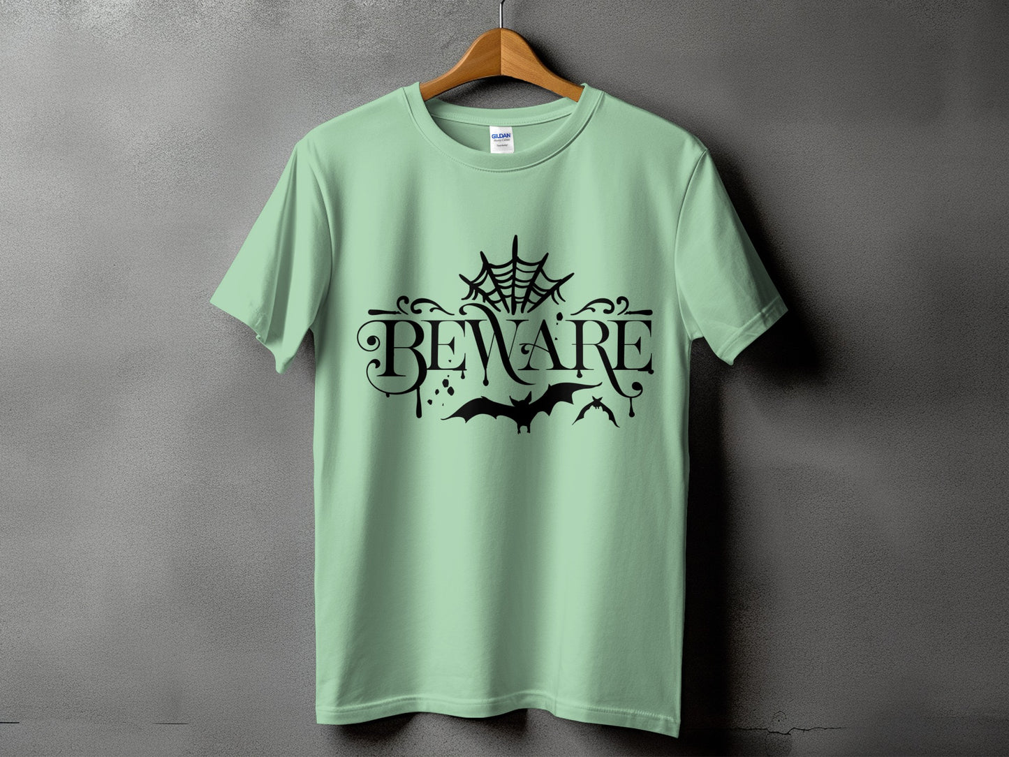 Light green t-shirt with "BEWARE" text, spiderweb, and bats graphic.