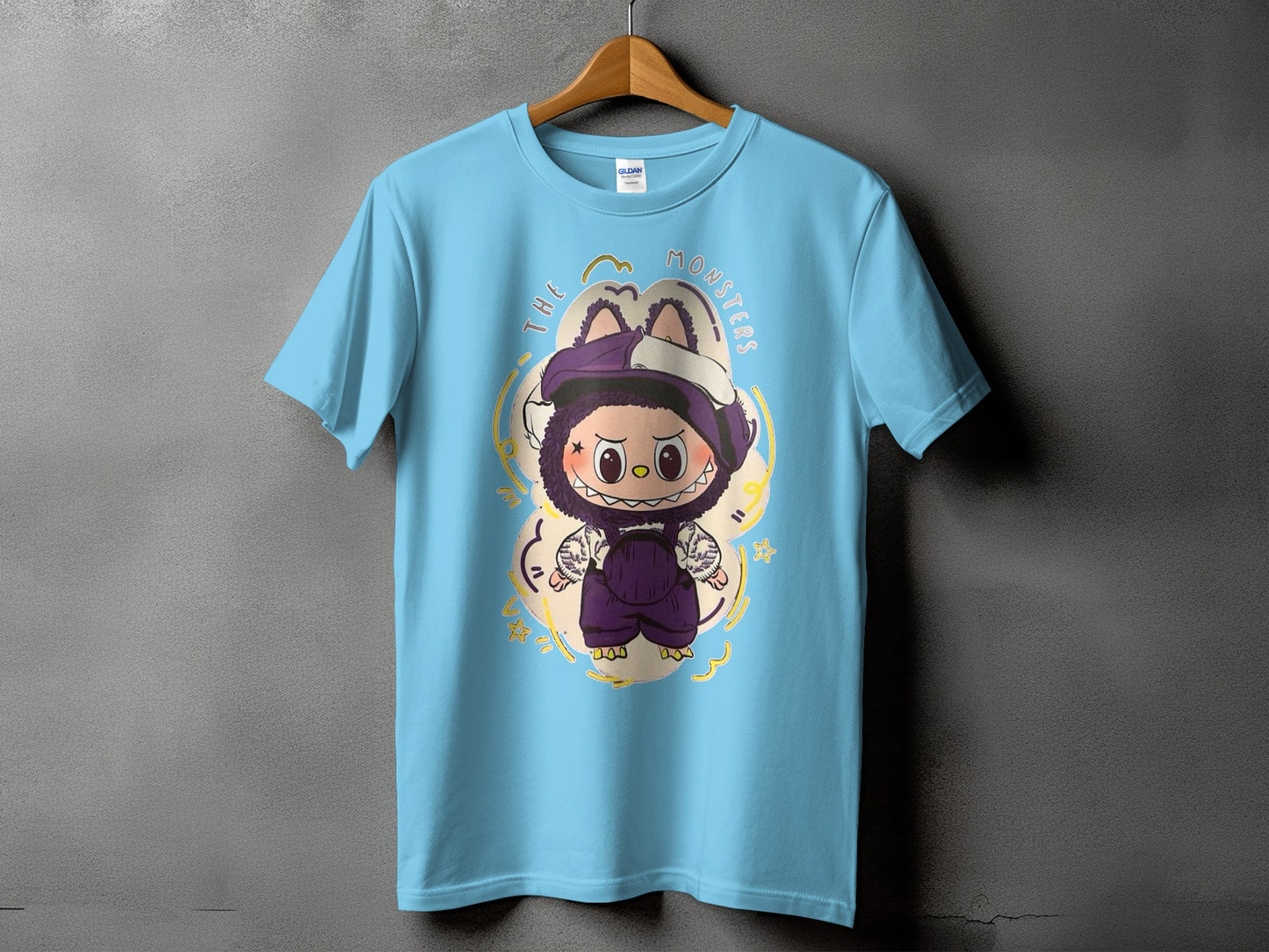 Light blue t-shirt with a cartoon monster and "THE MONSTERS" text design.