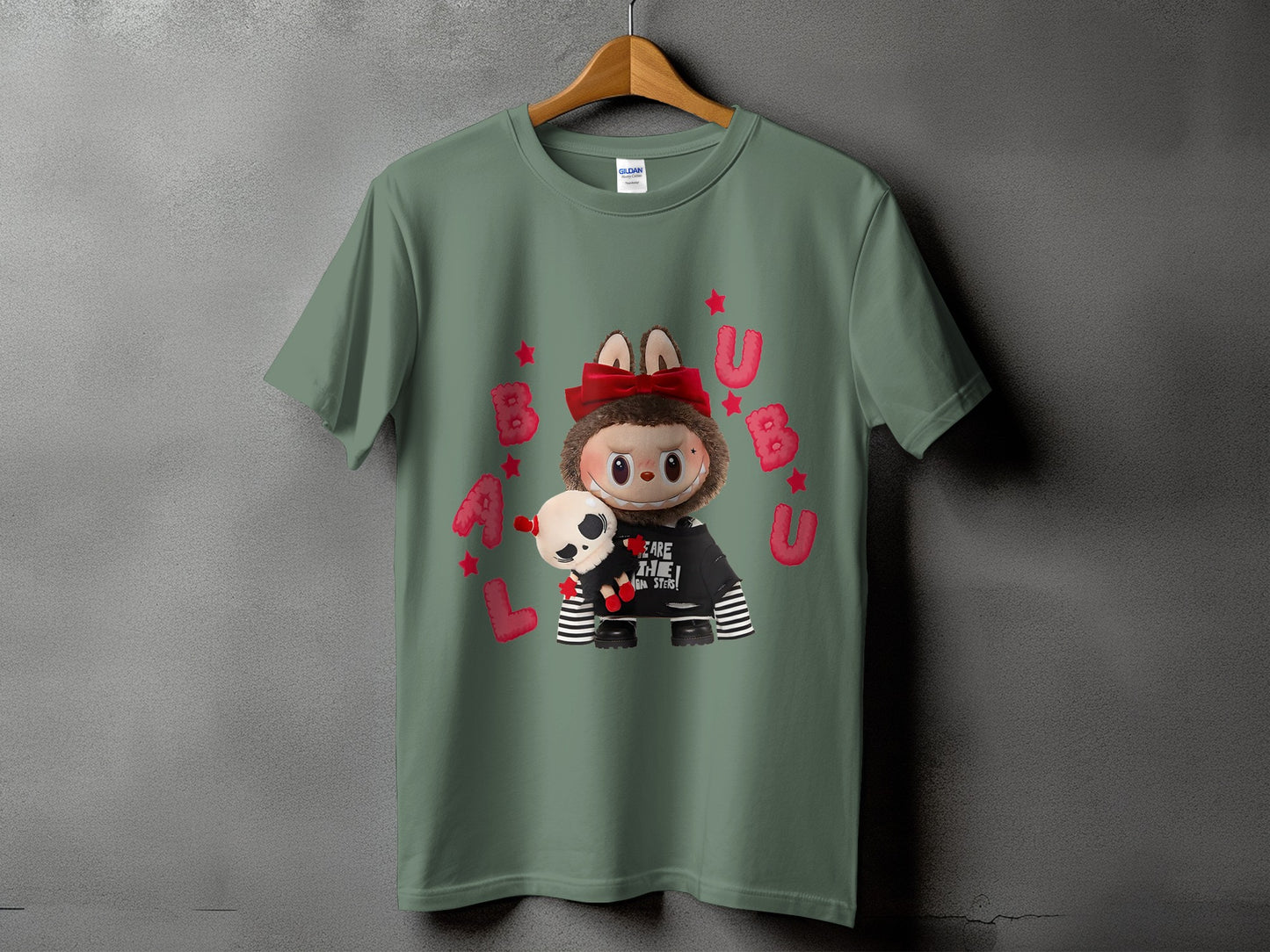 Green t-shirt with a creature wearing a hoodie and holding a skull plush.