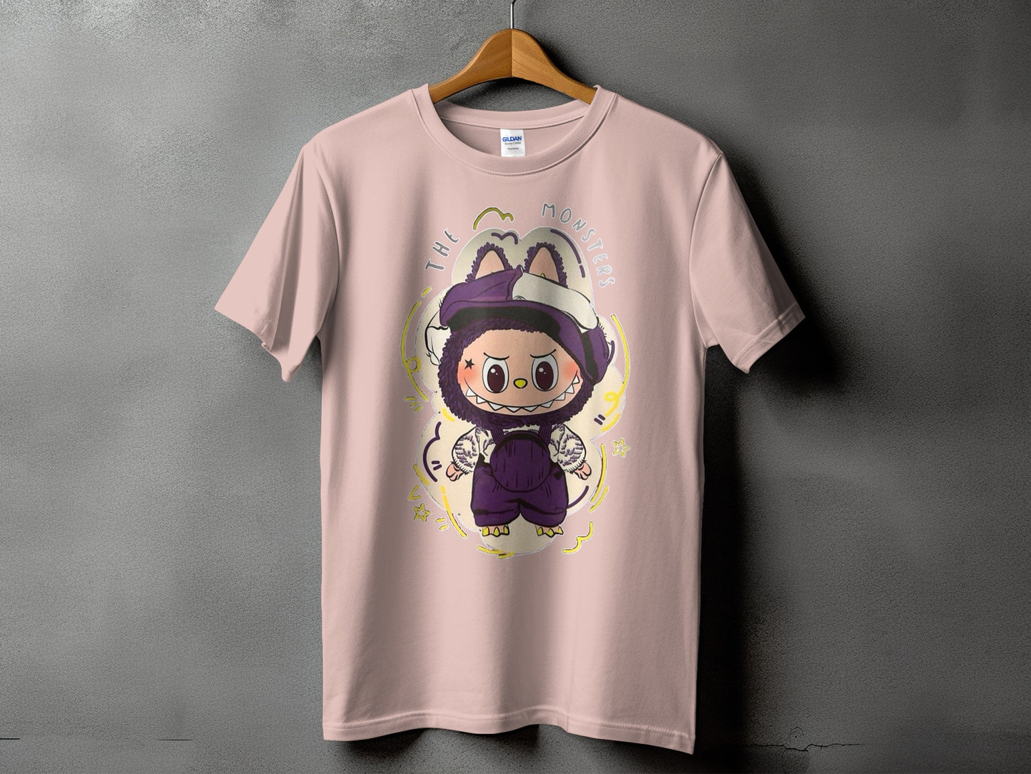 Pink t-shirt with a cartoon monster graphic and text "THE MONSTERS".