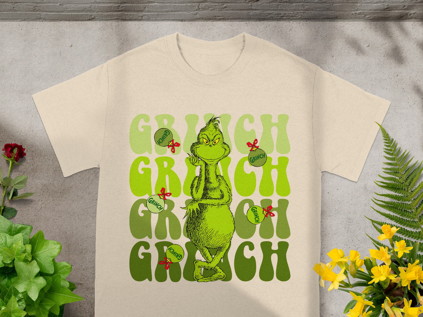 Cream t-shirt with Grinch graphic and "Grinch" text.